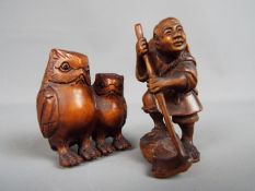 Two carved wood netsuke, the first depicting two owls, the other depicting a rice farmer,