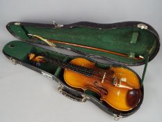 A 3/4 size violin with bow and chin support in hard protective case