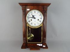 A Lincoln wall clock with key and pendulum