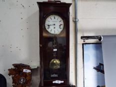 A Knight & Gibbins wall clock with key and pendulum.