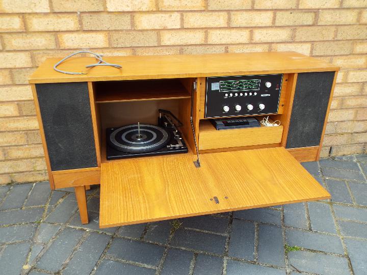 A vintage sideboard stereo system comprising stereo, turntable and tape deck,