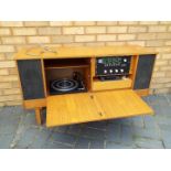 A vintage sideboard stereo system comprising stereo, turntable and tape deck,