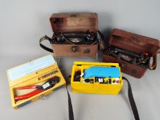 Three vintage GPO / BT field telephones and a cased set of ERMA crimping pliers.