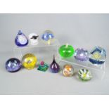 A collection of Caithness and similar paperweights.