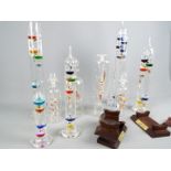 Five Galileo thermometers, largest approximately 43 cm (h) and four ships in bottles.