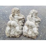 Garden Stoneware - A lot of two reconstituted stone garden wall decorations one a Baccus Cherub