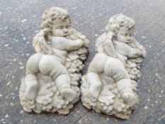 Garden Stoneware - A lot of two reconstituted stone garden wall decorations one a Baccus Cherub