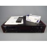 A Sony DAT, Digital Audio Tape deck, model 59ES, with remote and box of blank tapes.