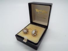 A pair of 9ct gold and white opal earrings, approximately 2.69 grams all in.