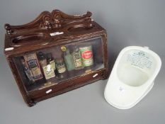 A display of vintage chemist's products and similar and a 'New Slipper Ben Pan'.