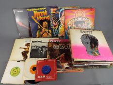 In excess of sixty 33 RPM vinyl records to include Jimi Hendrix, Hawkwind, Fleetwood Mac,