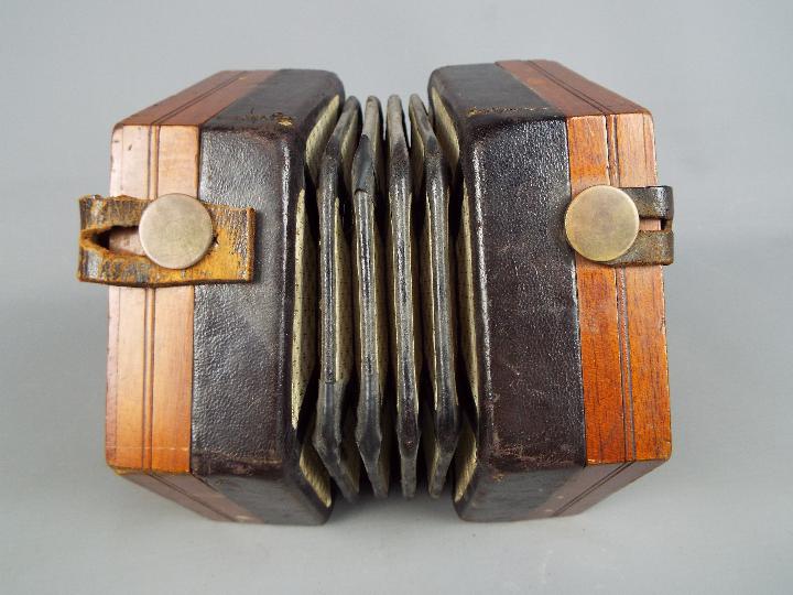 A Lachenal & Co 48 button concertina with hexagonal fretworked ends, - Image 5 of 5