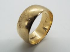 A 9ct gold hallmarked wedding band, size T, approximately 7.35 grams all in.