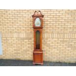 A modern Westminster chime grandmother clock with pendulum and three brass weights