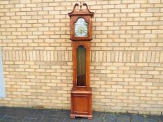 A modern Westminster chime grandmother clock with pendulum and three brass weights