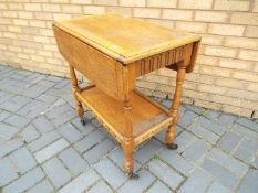 A drop leaf trolley approximately 74 cm x 67 cm x 43 cm when unextended.