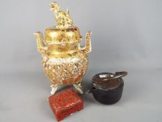 A large Meiji period Satsuma koro and cover of oviform with twin pierced handles and raised on