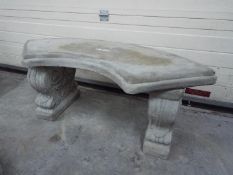 Garden Stoneware - A reconstituted stone garden bench with a curved seat and classic plinths