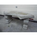 Garden Stoneware - A reconstituted stone garden bench with a curved seat and classic plinths