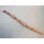 A Rastafarian carved stick, approximately 114 cm.