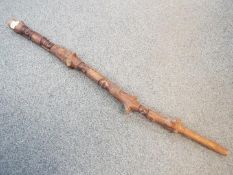 A Rastafarian carved stick, approximately 114 cm.