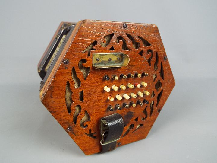 A Lachenal & Co 48 button concertina with hexagonal fretworked ends, - Image 4 of 5