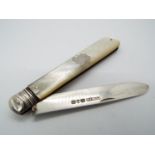 A Victorian silver and mother of pearl folding fruit knife, vacant cartouche to the handle,