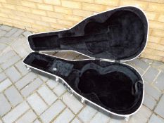 A hard carry case for a dreadnought type acoustic.