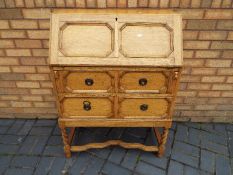 A bureau with fall flap front and two drawers, approximately 104 cm x 76 cm x 42 cm.