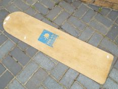 A vintage Piran Surfboards wooden belly board, approximately 121 x 30 cm.