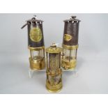 Three safety lamps to include one marked Protector Lamp & Lighting Co, Eccles Manchester,