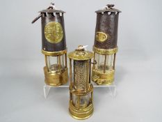 Three safety lamps to include one marked Protector Lamp & Lighting Co, Eccles Manchester,