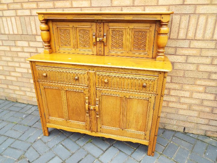 A large sideboard approximately 129 cm x 125 cm x 50 cm.