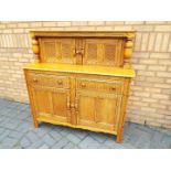 A large sideboard approximately 129 cm x 125 cm x 50 cm.