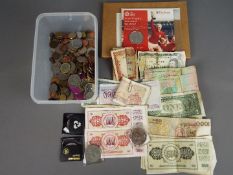 A quantity of UK and foreign coins and banknotes and a 1966 World Cup commemorative coin.