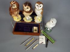 A wooden box containing a small quantity of pens to include Parker,