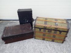 A vintage dome top shipping trunk, wooden chest and vintage suitcase.