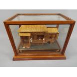 An early 20th century Japanese wood and bamboo work model of a pagoda type house with stand