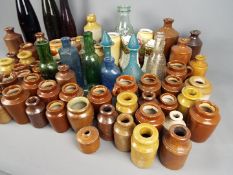 A collection of stoneware and glass bottles and pots, early to mid 20 th century,