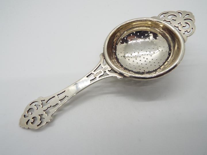 Three pieces of hallmarked silver to include a George V tea strainer, Birmingham assay 1932, - Image 3 of 4