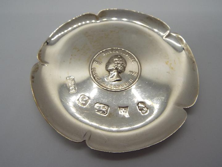 Three pieces of hallmarked silver to include a George V tea strainer, Birmingham assay 1932, - Image 2 of 4