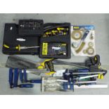 A mixed lot of hand tools, cased electric drill, clamps and similar.