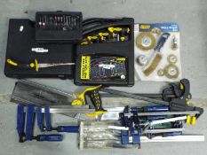 A mixed lot of hand tools, cased electric drill, clamps and similar.