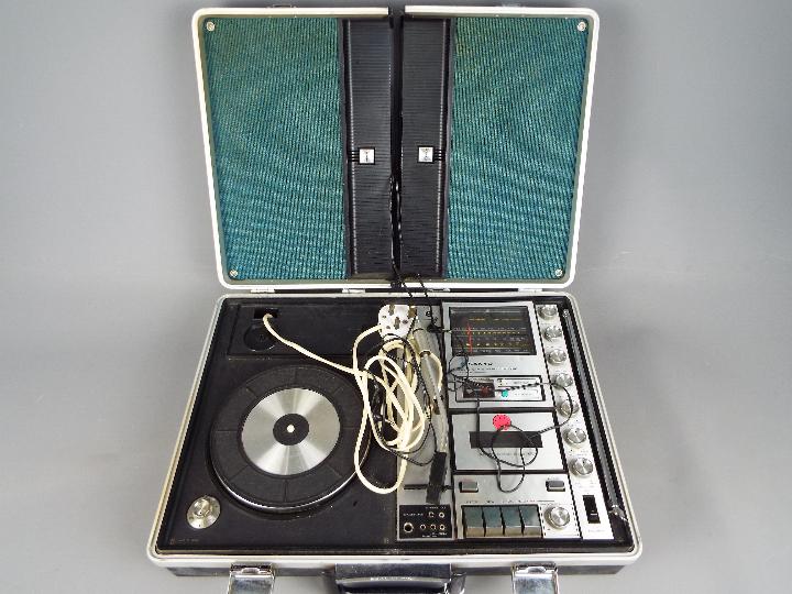 A vintage Sanyo Solid State Music Centre in briefcase, model G-2615N-2.