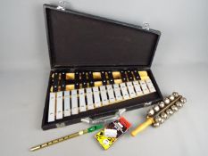 A cased tenor alto glockenspiel, tin whistle, sleigh bells and similar.