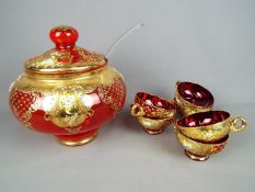 A Venetian, ruby glass punch bowl and cover with six glasses,