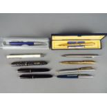 A collection of pens and propelling pencil to include Parker,