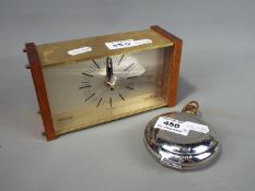 A Dalvey St Elmo travel alarm clock and a Westclox mantel clock.