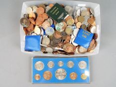 A quantity of UK and foreign coins, commemorative crowns and other.