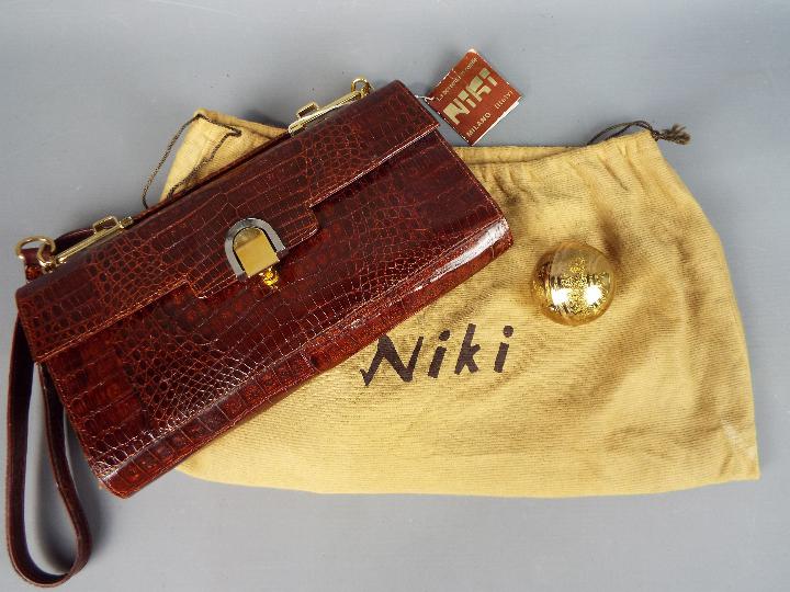 A vintage Italian crocodile skin handbag by Niki of Milan with dust cover and a Pygmalion yellow